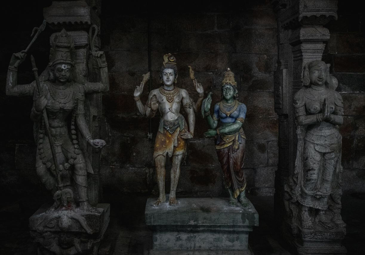Intricate stone statues depicting Hindu deities in Tiruchirappalli, India.