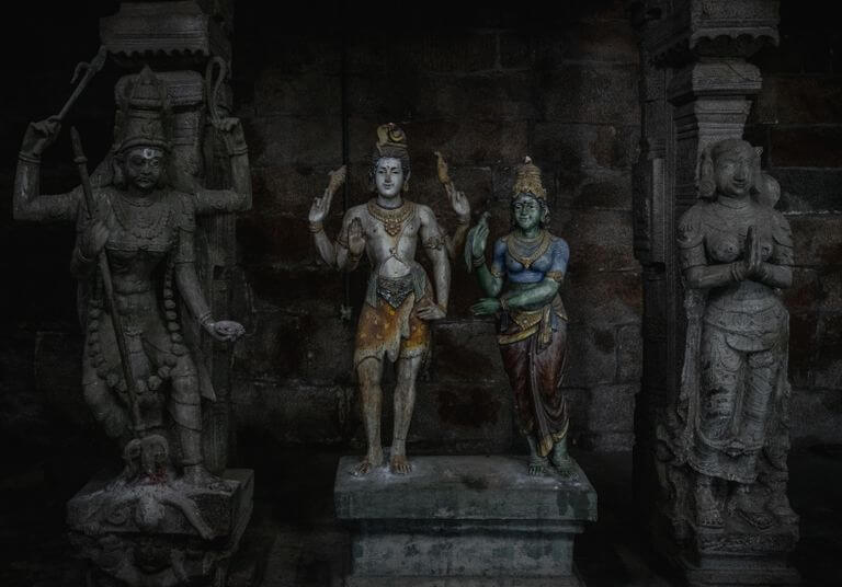 Intricate stone statues depicting Hindu deities in Tiruchirappalli, India.